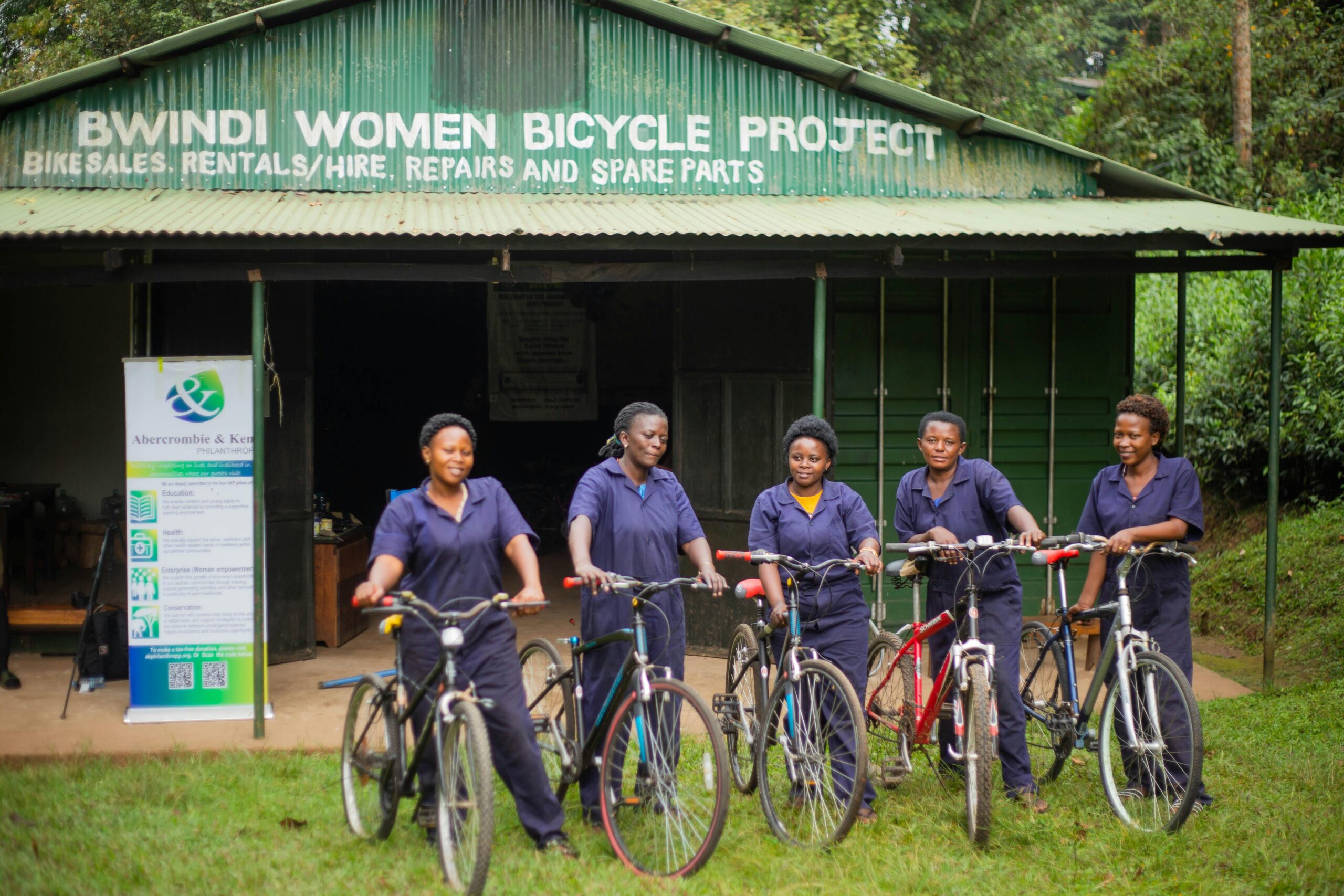 Women from the Bwindi Bicycle Project pose with bicycles, promoting local empowerment.